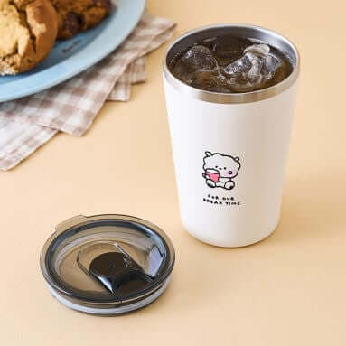 BT21 Basic Tumblr Cup 473ml on a table with a lid and iced drink, featuring a cute character design.