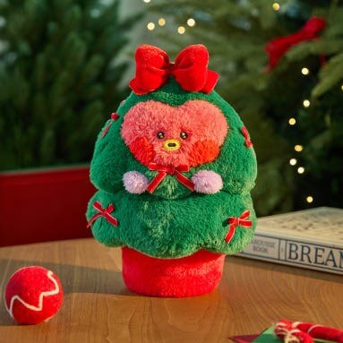 BT21 Minini Petit Holiday Tree Plushy with festive decorations on a table for holiday ambiance.