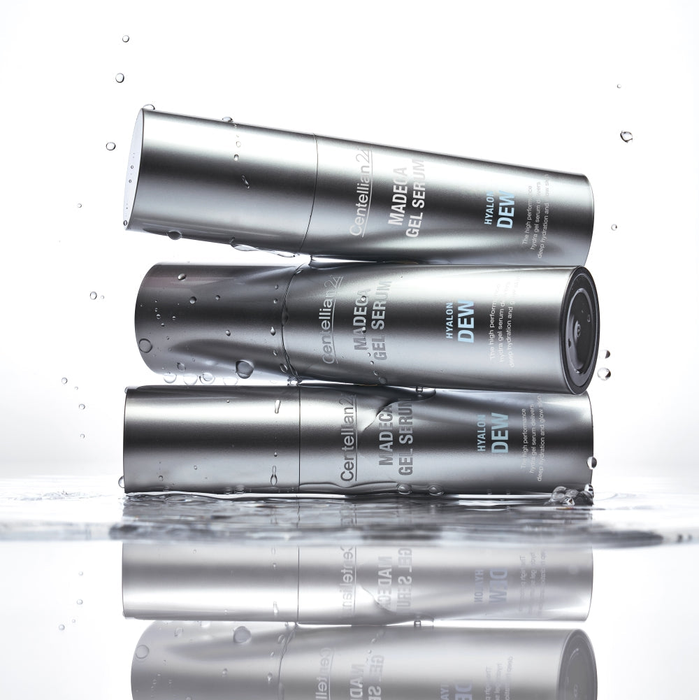 Three bottles of CENTELLIAN 24 Madeca Gel Serum Hyalon Dew 30ml stacked with water droplets, showcasing the product’s design and texture.