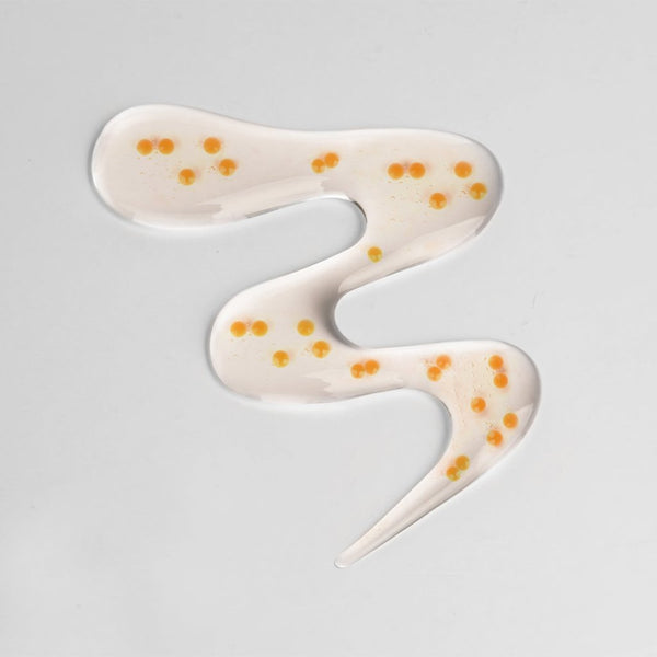 Texture of CENTELLIAN 24 Madeca Vital Capsule Serum 50ml with visible serum capsules