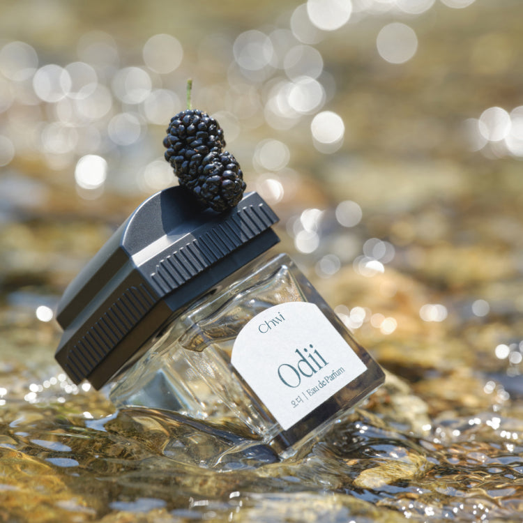 CHWI (CHI) Odii Parfume 50ml bottle with blackberry accent in natural setting