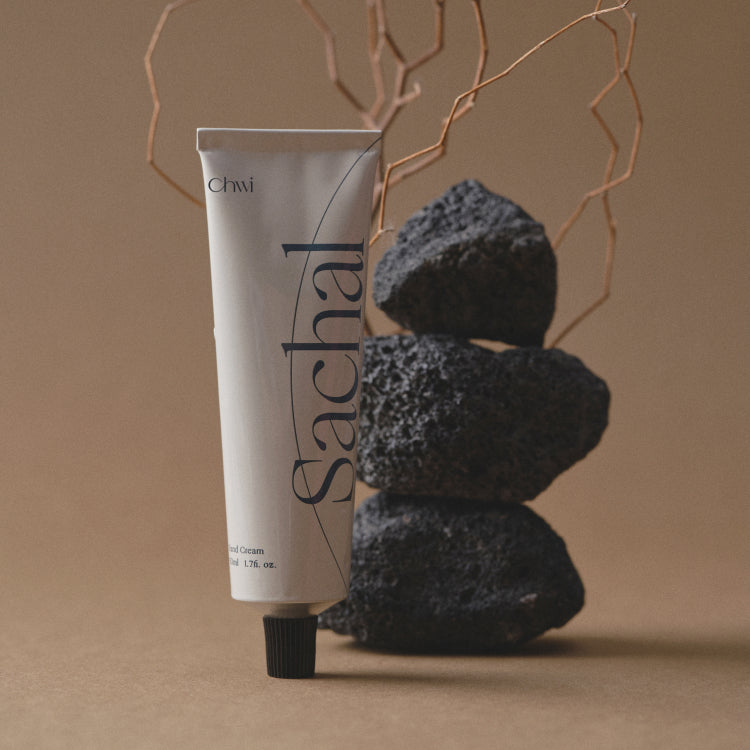 Tube of CHWI (CHI) Sachal Hand Cream 50ml displayed elegantly with natural stones in the background.