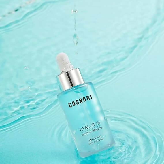 COSNORI Hyaluronic Moisture Ampoule 30ml displayed on a watery surface, highlighting its hydrating properties and sleek design.