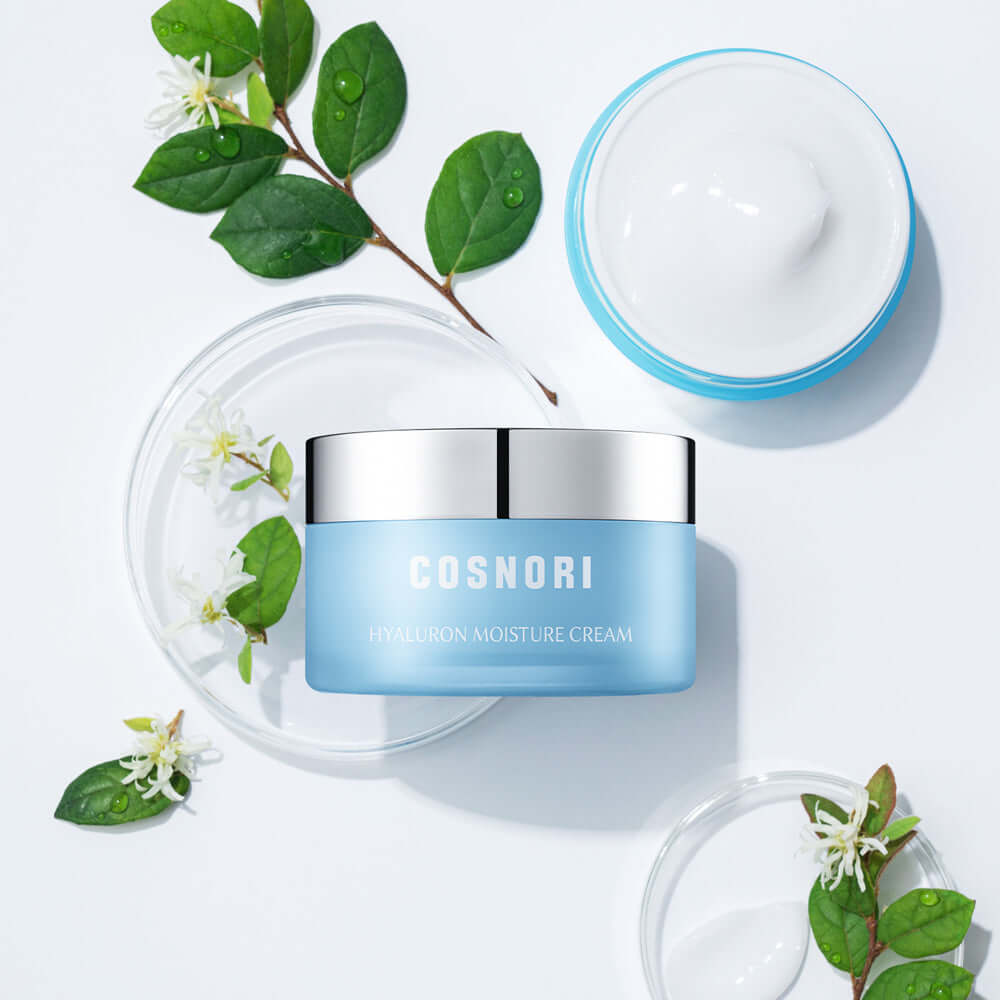 COSNORI Hyaluronic Moisture Cream 50ml container surrounded by green leaves on a white background