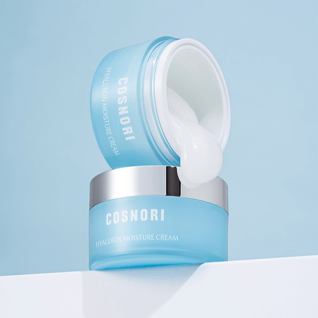 COSNORI Hyaluronic Moisture Cream 50ml in blue container with open lid, showing the cream's texture against a light blue background.
