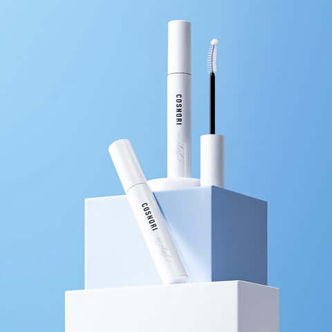 COSNORI Long Active Eyelash Serum displayed on geometric white and blue pedestal against a blue background.