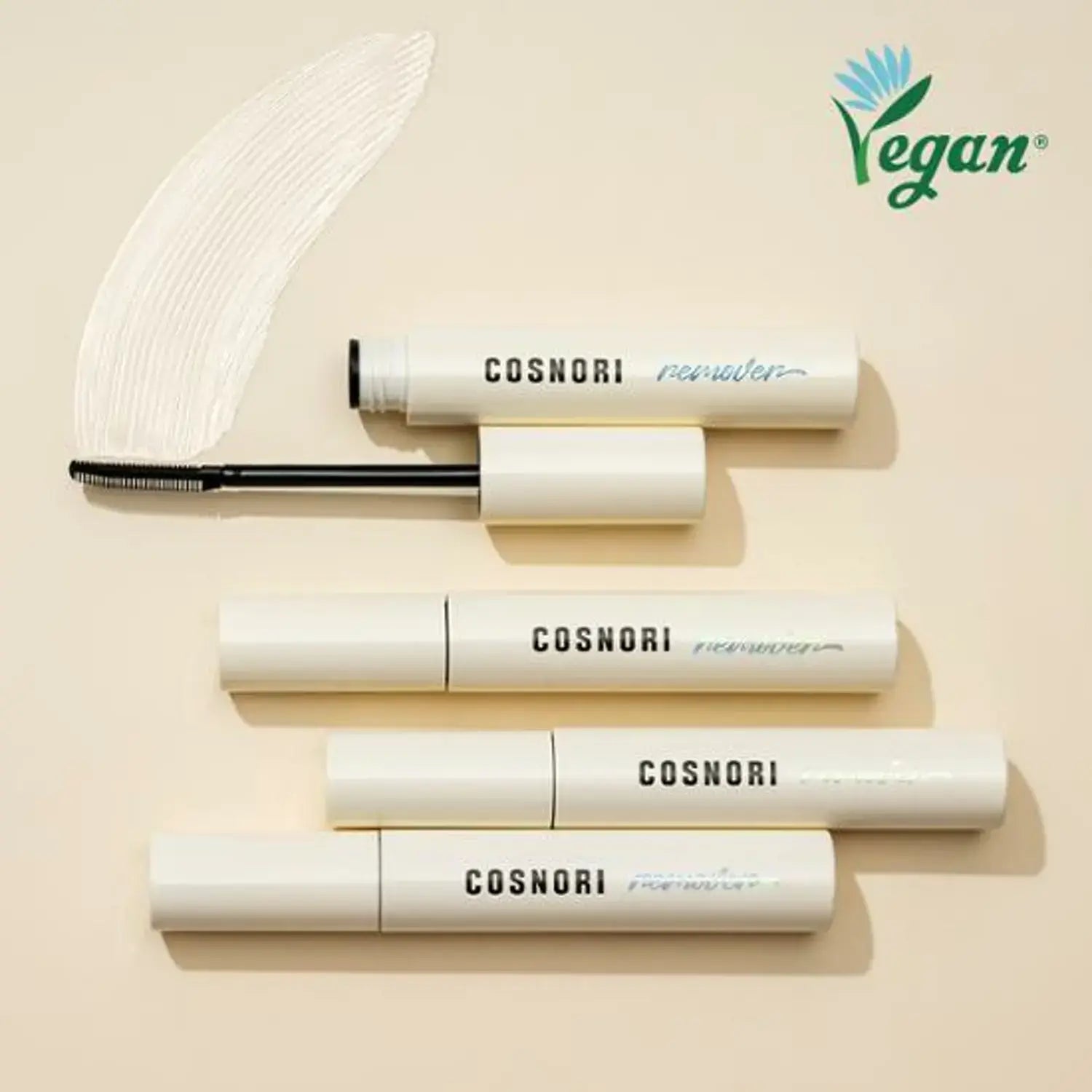 COSNORI Long Active Mascara Remover in white packaging with vegan label, showcasing open and closed tubes on a beige background.