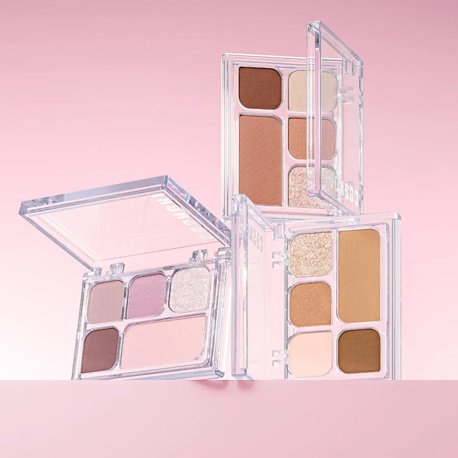 COSNORI My Moment Eye Palette featuring a range of neutral and shimmer eyeshadows in open compact cases on a pink background.