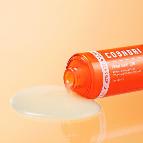 COSNORI PDRN Shot 675 50ml ampoule bottle with liquid pouring on peach background