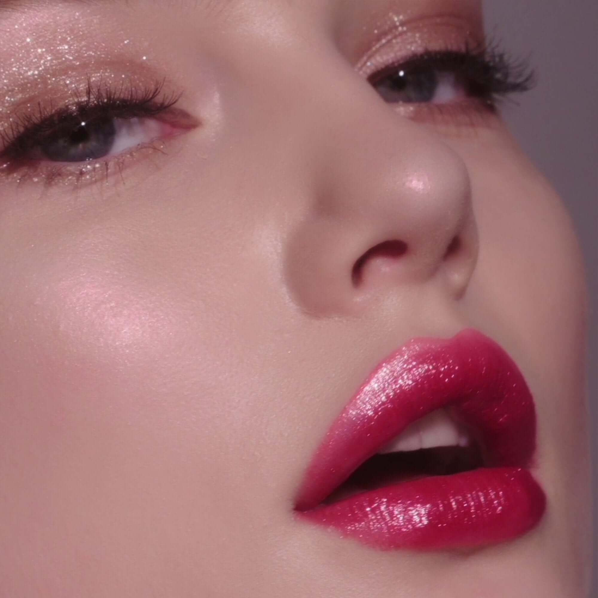 Close-up of lips wearing DEAR DAHLIA Allure Shine Lustrous Lip Plumper, showcasing glossy and vibrant finish.