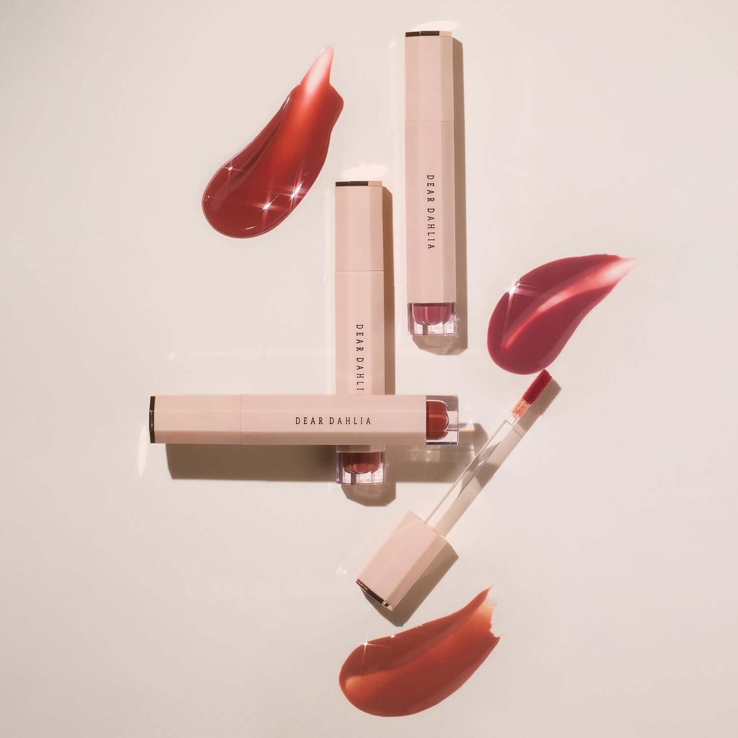 DEAR DAHLIA Blooming Edition Satin Glow Lip Stain tubes and swatches on a light background.