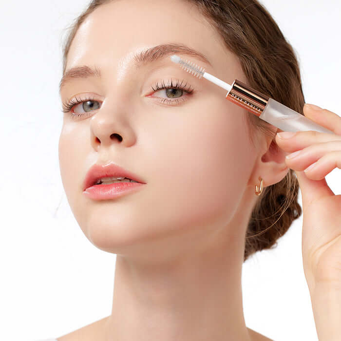 Model applying DEAR DAHLIA Dream Lash Dual Serum to eyelashes for enhanced lash growth and strength.