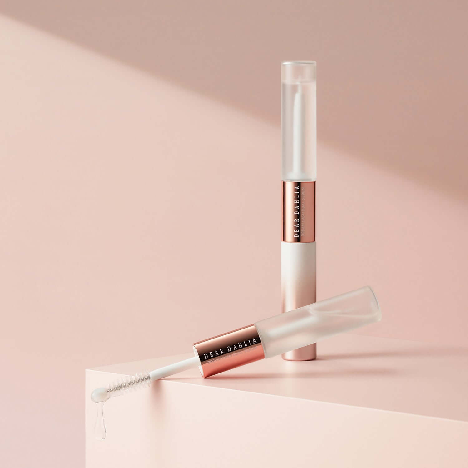 DEAR DAHLIA Dream Lash Dual Serum on display with rose-gold accents, showcasing luxury lash care packaging.