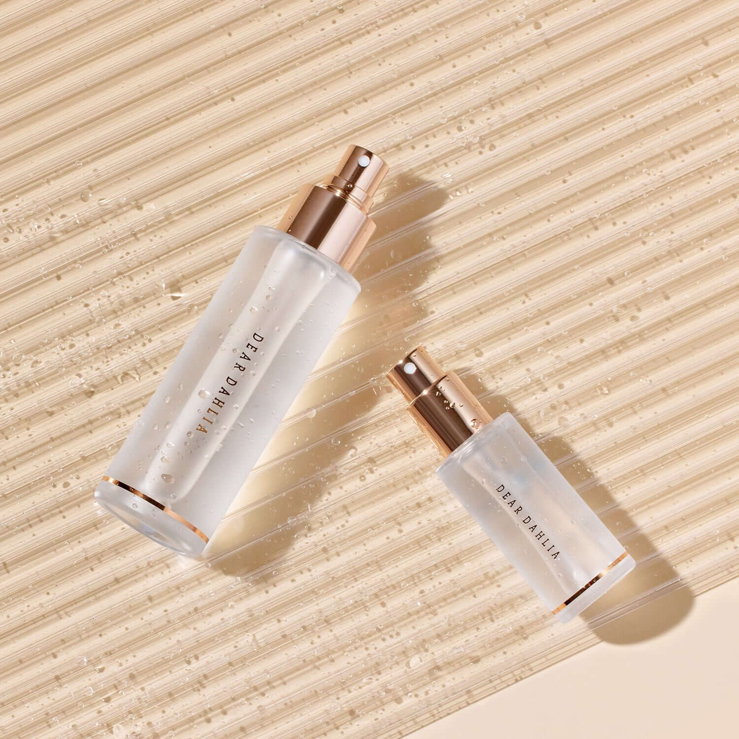 DEAR DAHLIA Endless SKin Setting Spray bottles on textured surface