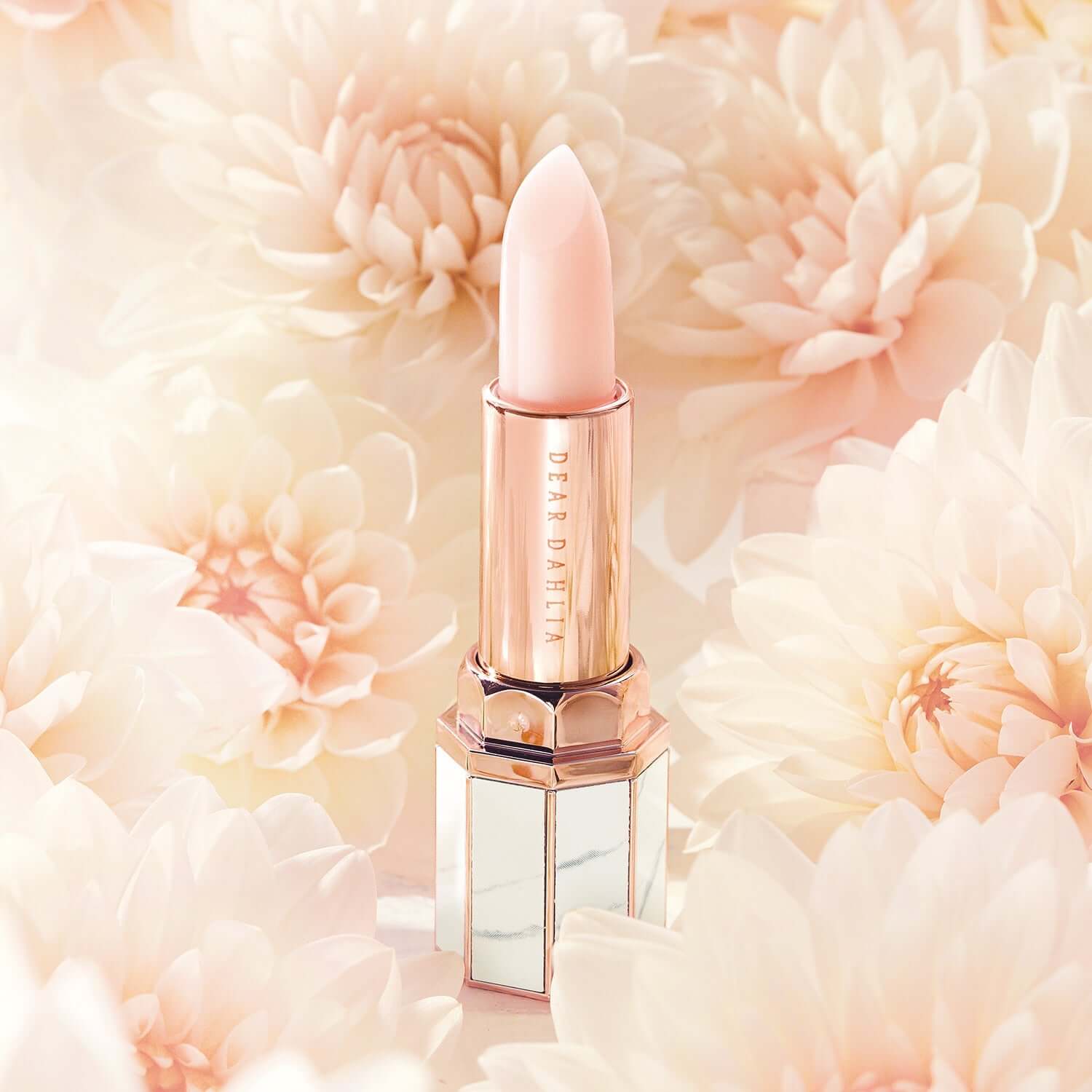 DEAR DAHLIA Paradise Blooming Night lipstick surrounded by dahlia flowers