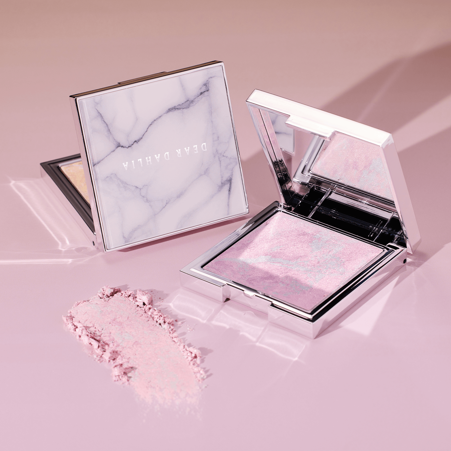 DEAR DAHLIA Skin Luminous Highlighter in elegant compact showcasing shimmering pink tones.