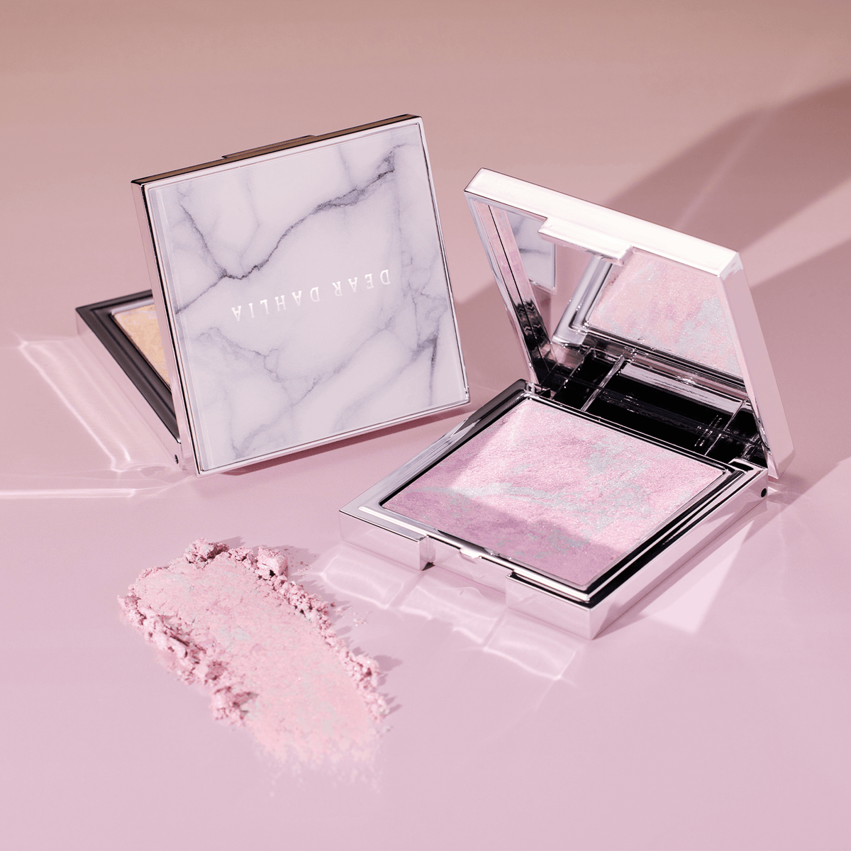 DEAR DAHLIA Skin Luminous Highlighter in elegant compact showcasing shimmering pink tones.