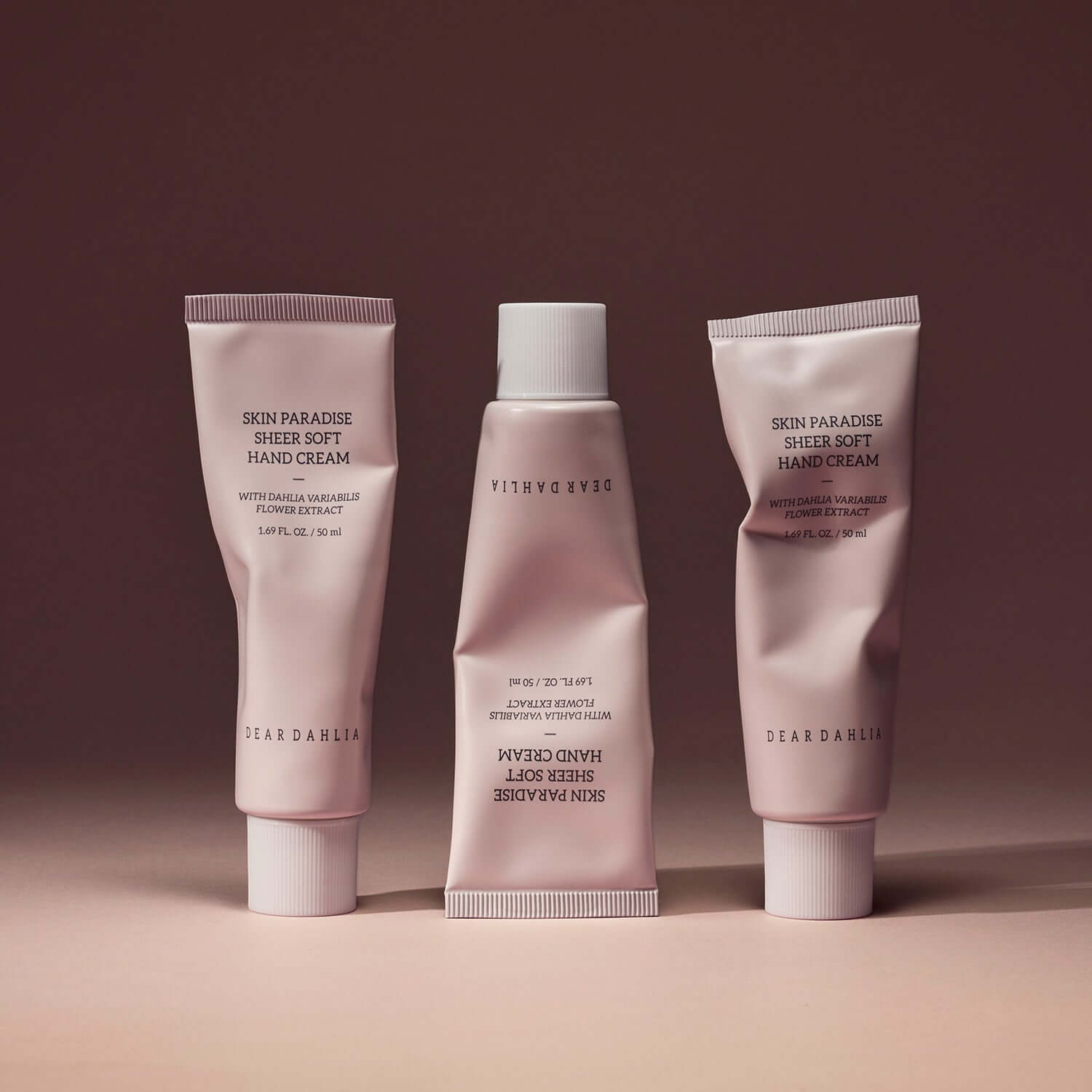 DEAR DAHLIA Skin Paradise Sheer Soft Hand Cream tubes on a neutral background