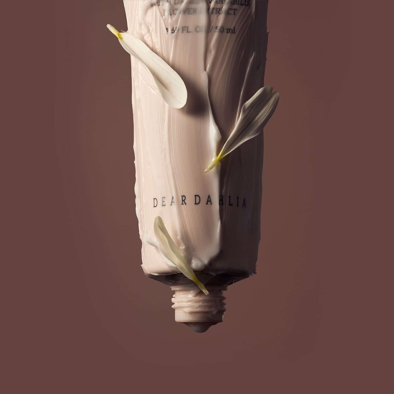 DEAR DAHLIA Skin Paradise Sheer Soft Hand Cream tube with floral accents against brown background