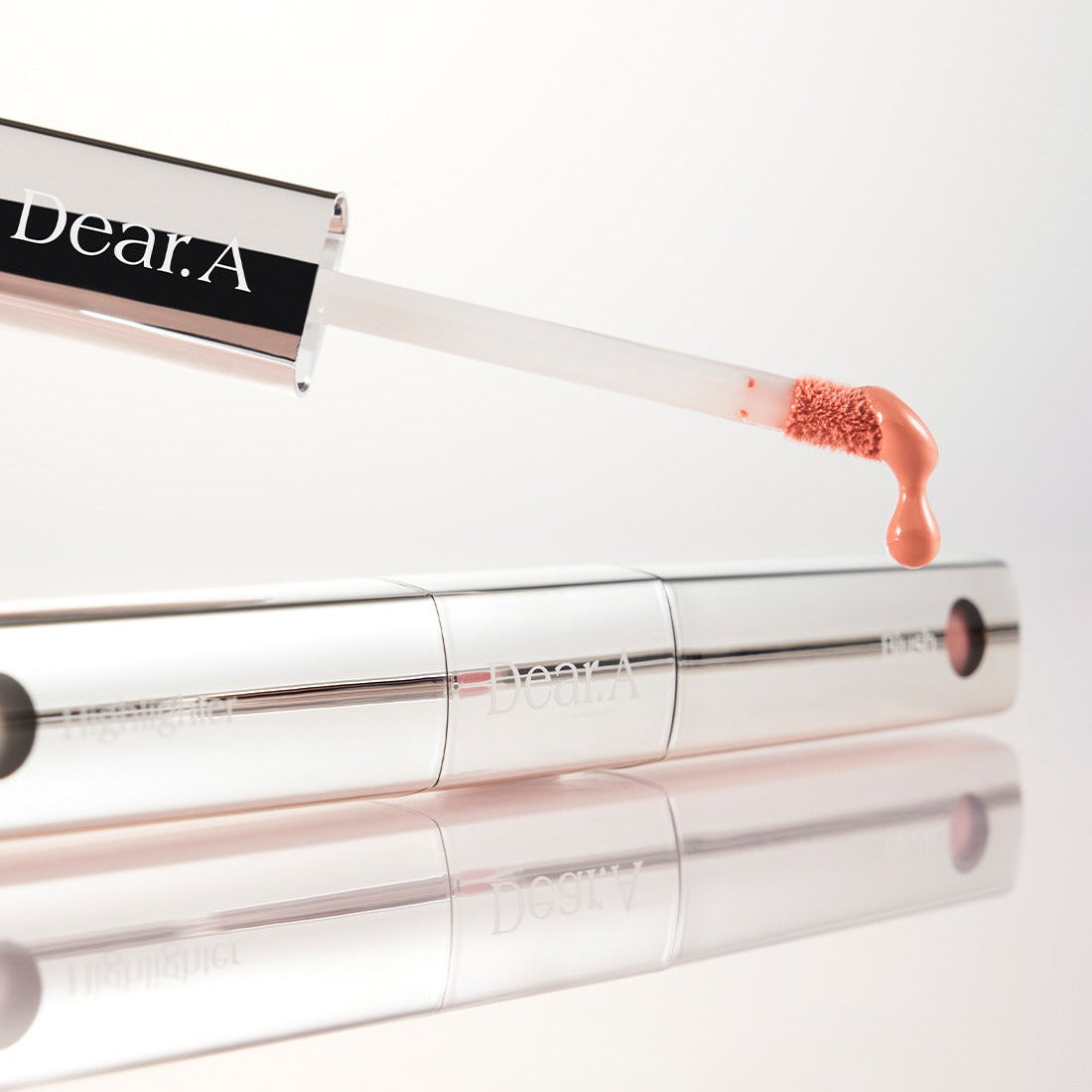 DEAR.A Blush & Beam Dual Stick beauty product in silver packaging with applicator, highlighting makeup innovation and elegance.