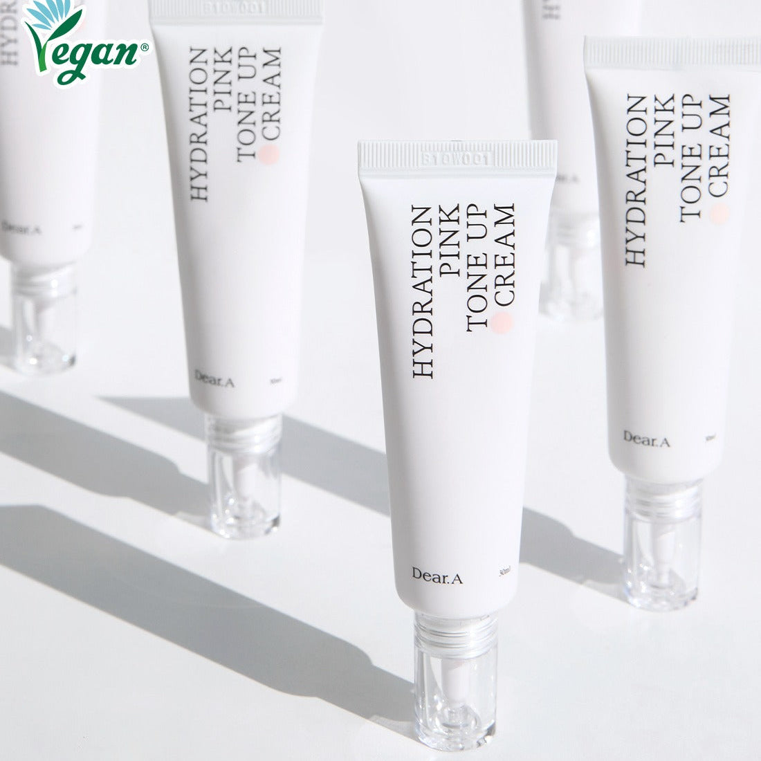 DEAR.A Hydration Pink Tone-Up Cream 30ml tubes arranged on a white surface, highlighting vegan-friendly skincare product.