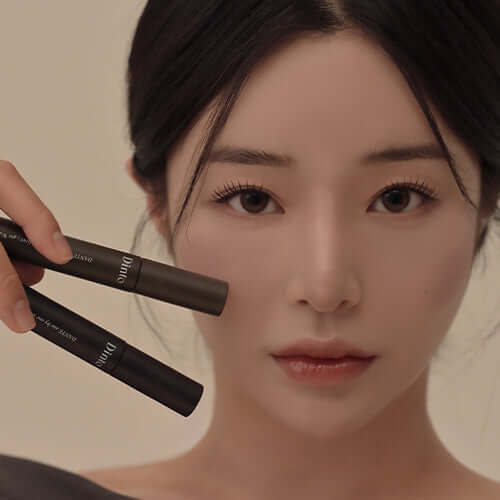 Woman holding DINTO Dante Lash Definer for eyelash enhancement