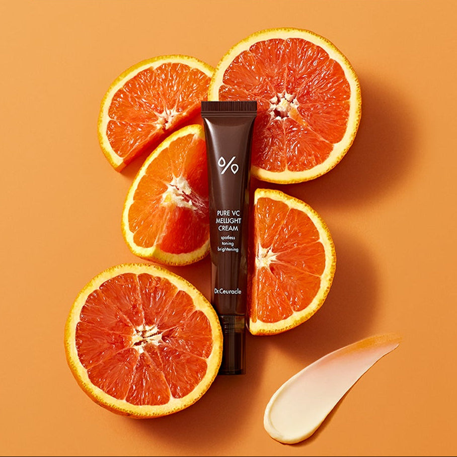 DR.CEURACLE Pure VC Melite Cream 20ml with fresh oranges on orange background, product packaging view.