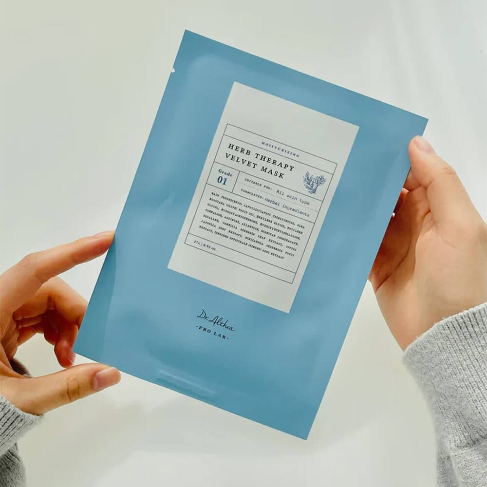 Hands holding DR.ALTHEA Herb Therapy Velvet Mask packaging