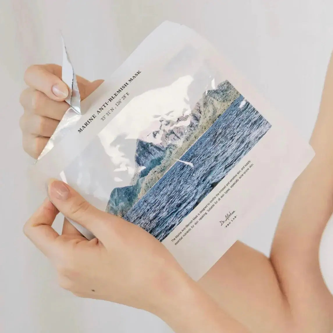 Hands holding DR.ALTHEA Marine Anti Blemish Mask (5ea) skincare product