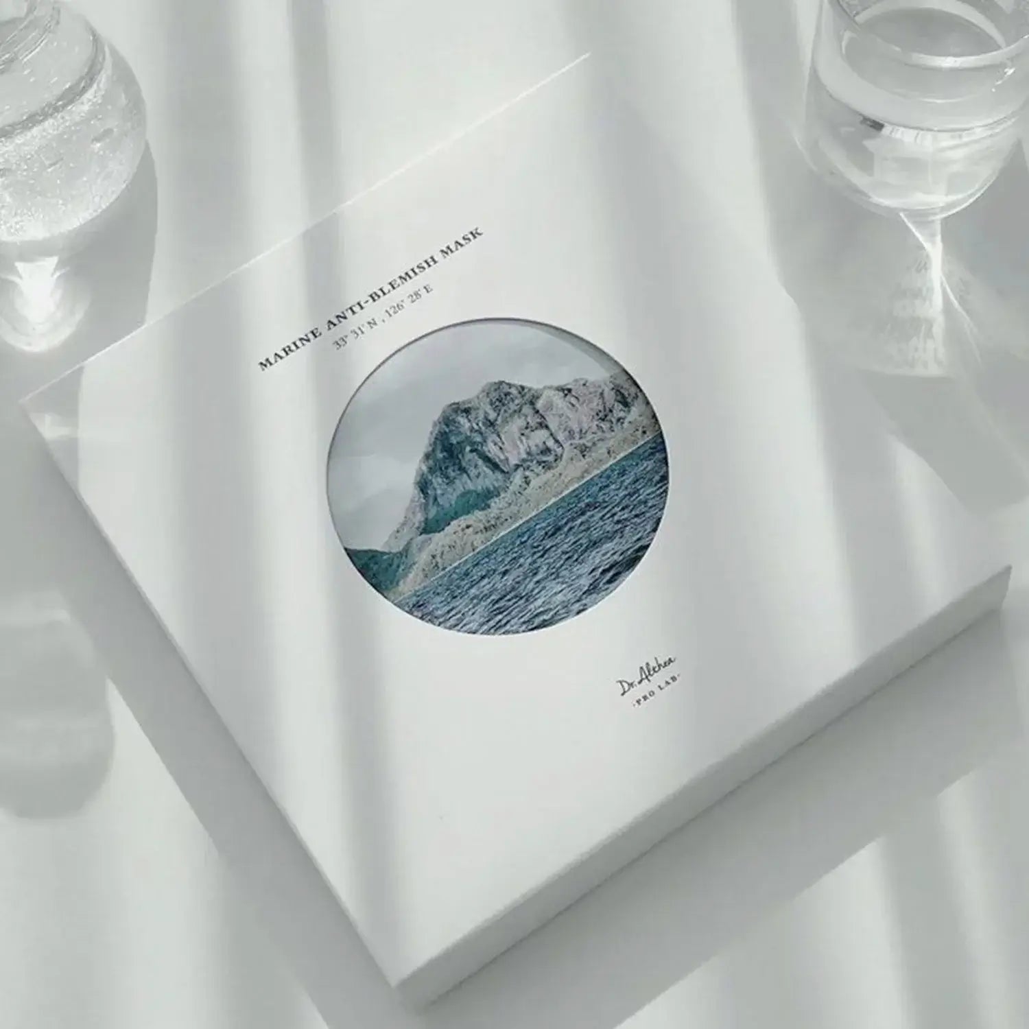DR.ALTHEA Marine Anti Blemish Mask (5ea) packaging with ocean and mountain design on a sunlit surface.