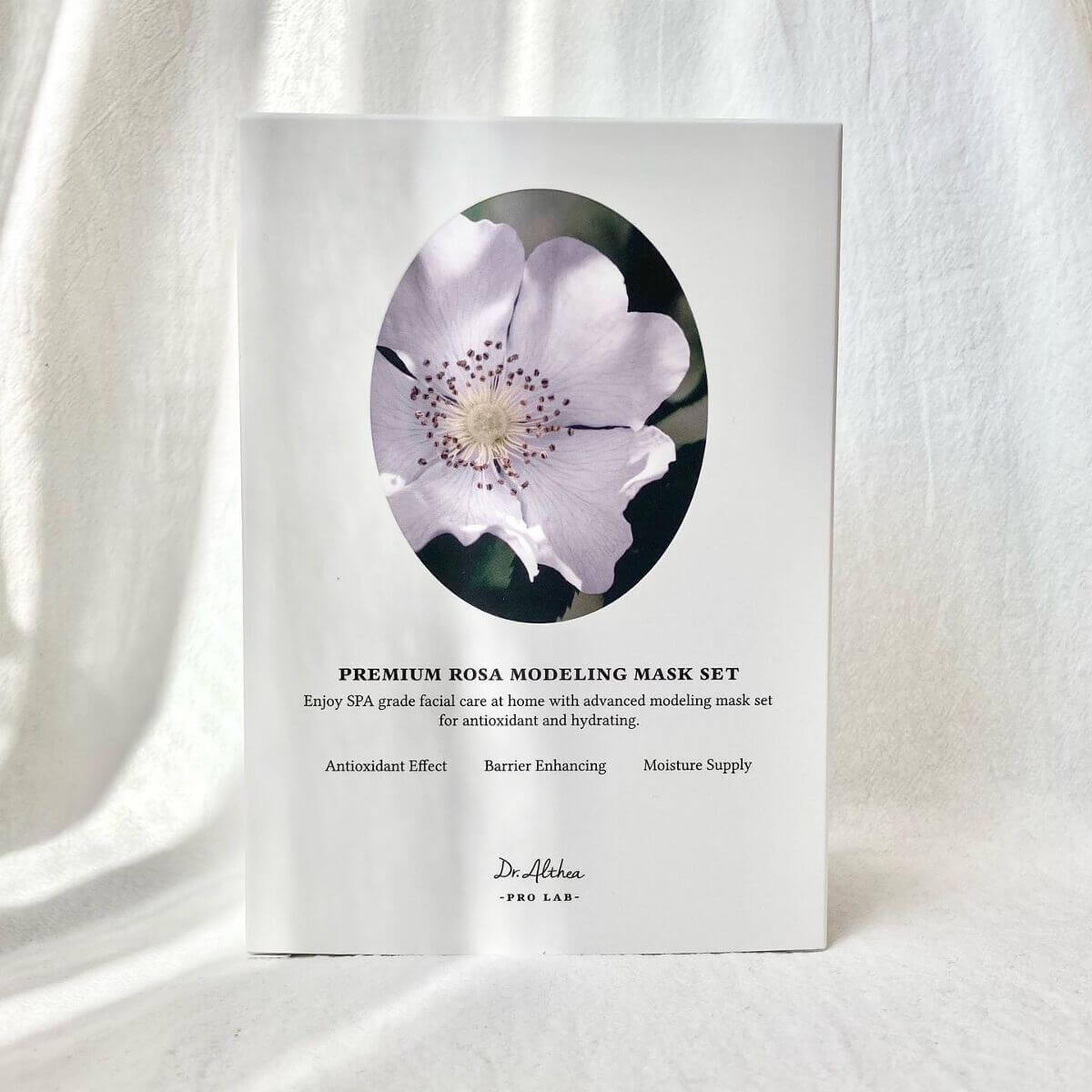 Image of DR.ALTHEA Premium Rosa Modeling Mask Set (5ea) 25g packaging with floral design; promoting antioxidant effect and moisture supply.