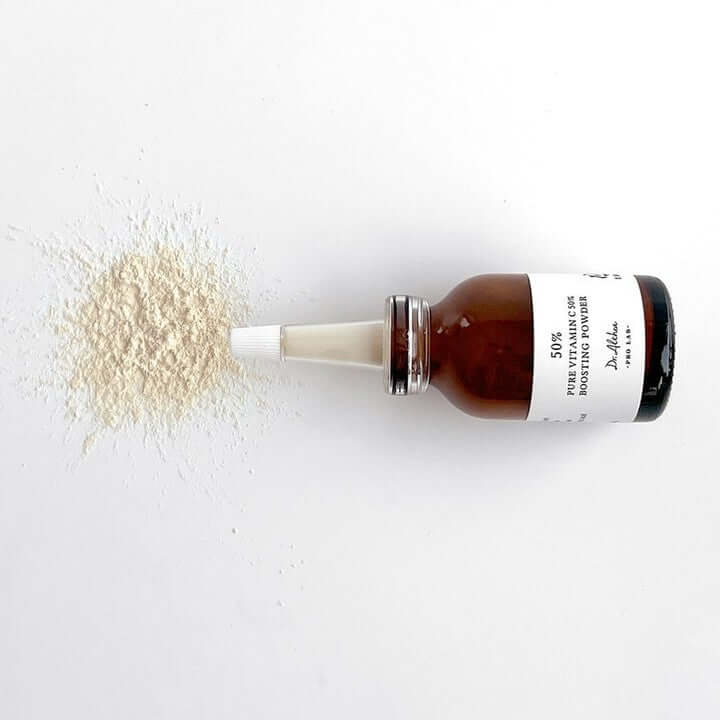 DR.ALTHEA Pure Vitamin C 50% Boosting Powder 10g bottle with powder spilled on a white surface.