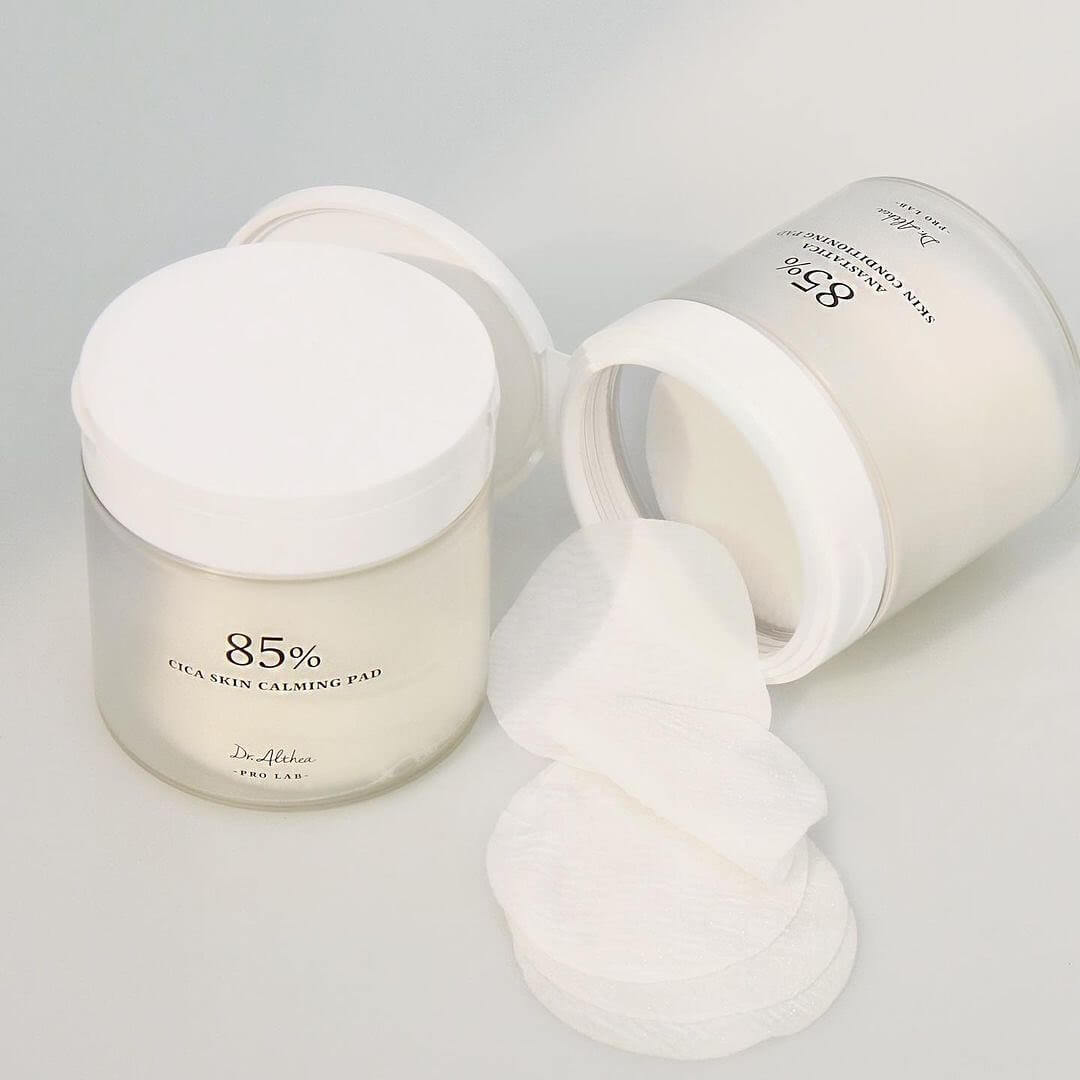 Open jar of DR.ALTHEA Resurrection SKin Conditioning Pad 170g with cotton pads displayed on a light background.