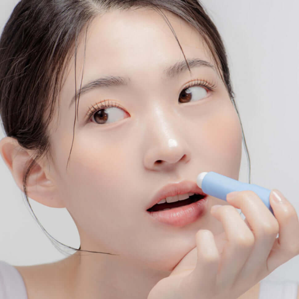Woman applying DR.ALTHEA Soft Malting Lip Balm