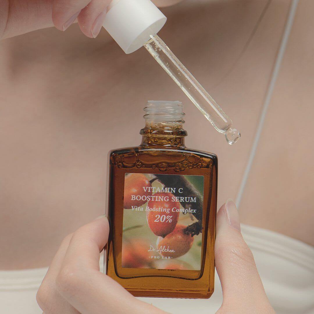 Close-up of DR.ALTHEA Vitamin C Boosting Serum 30ml being applied with dropper