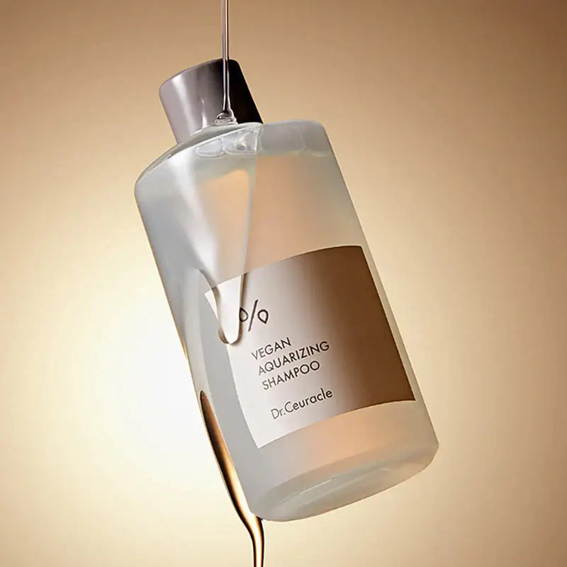 DR.CEURACLE Aqua Rising Shampoo 300ml bottle in elegant light setting.