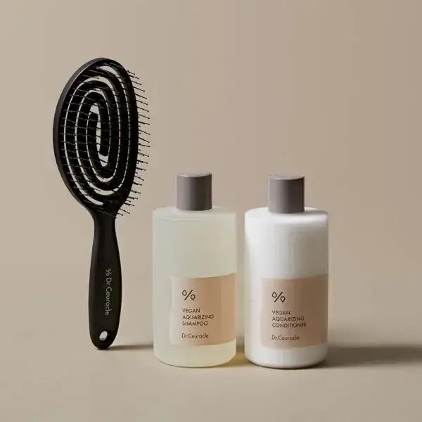 DR.CEURACLE Aqua Rising Shampoo 300ml with hairbrush and conditioner on beige background