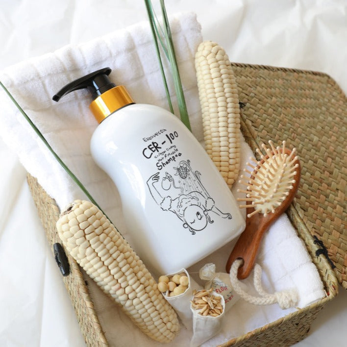 ELIZAVECCA Cer-100 Collagen Coating Hair A+ Muscle Shampoo 500ml bottle in wicker basket with corn and hairbrush