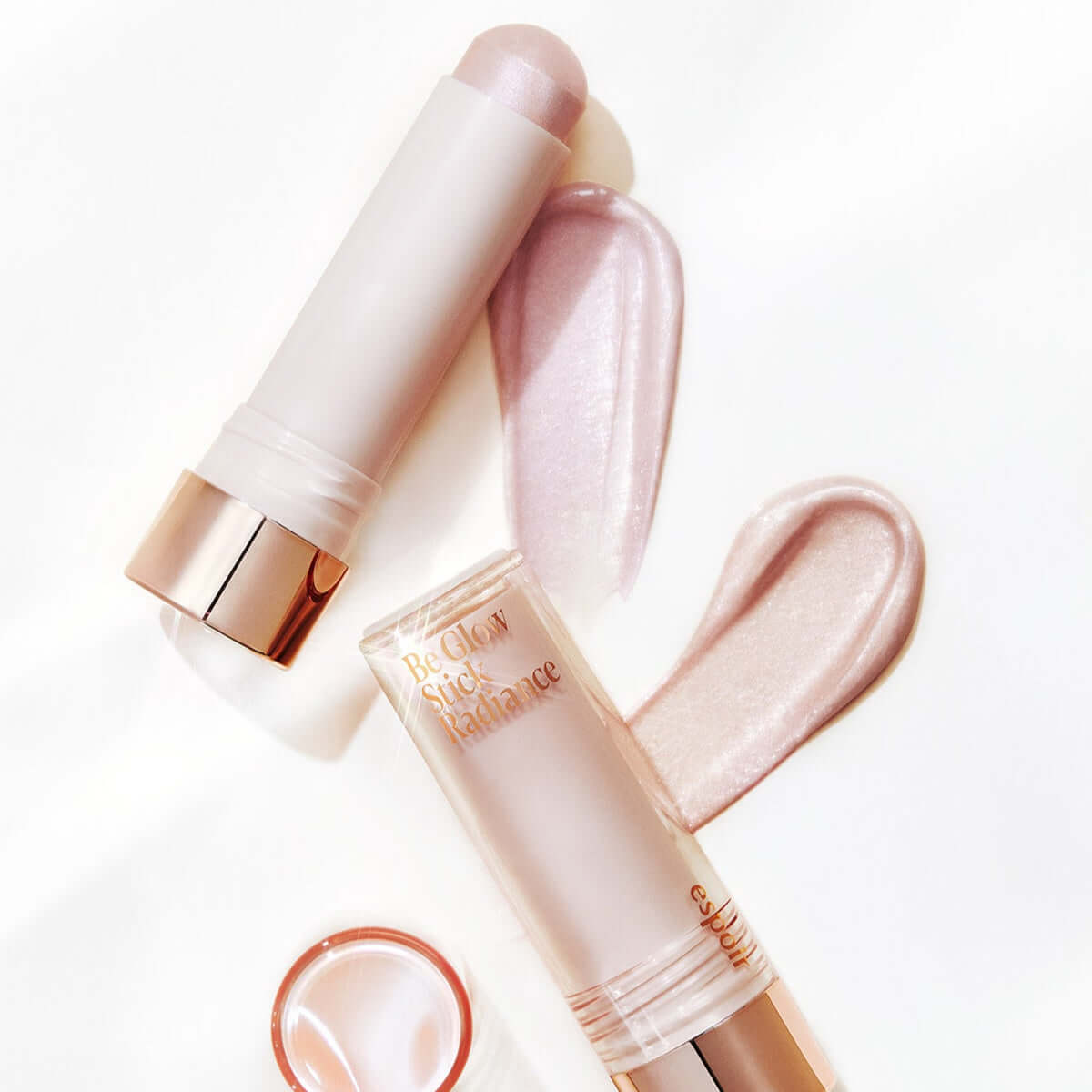 ESPOIR BE GLOW STICK RADIANCE highlighting makeup product on white background with swatches of shimmer.
