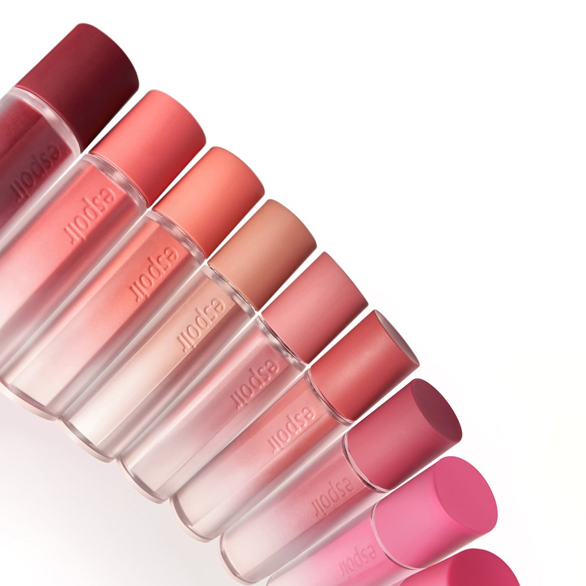 Colorful bottles of ESPOIR Couture Lip Tint Fitting Blur in various shades displayed in a diagonal arrangement.