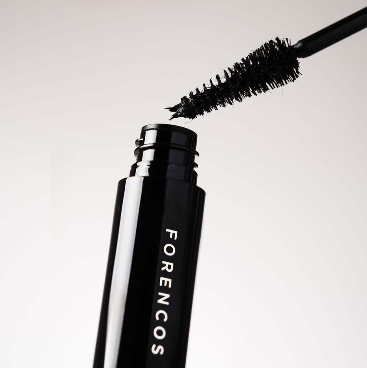 Open tube of FORENCOS Renewal Tattoo Allproof Mascara showcasing the brush with rich black mascara.