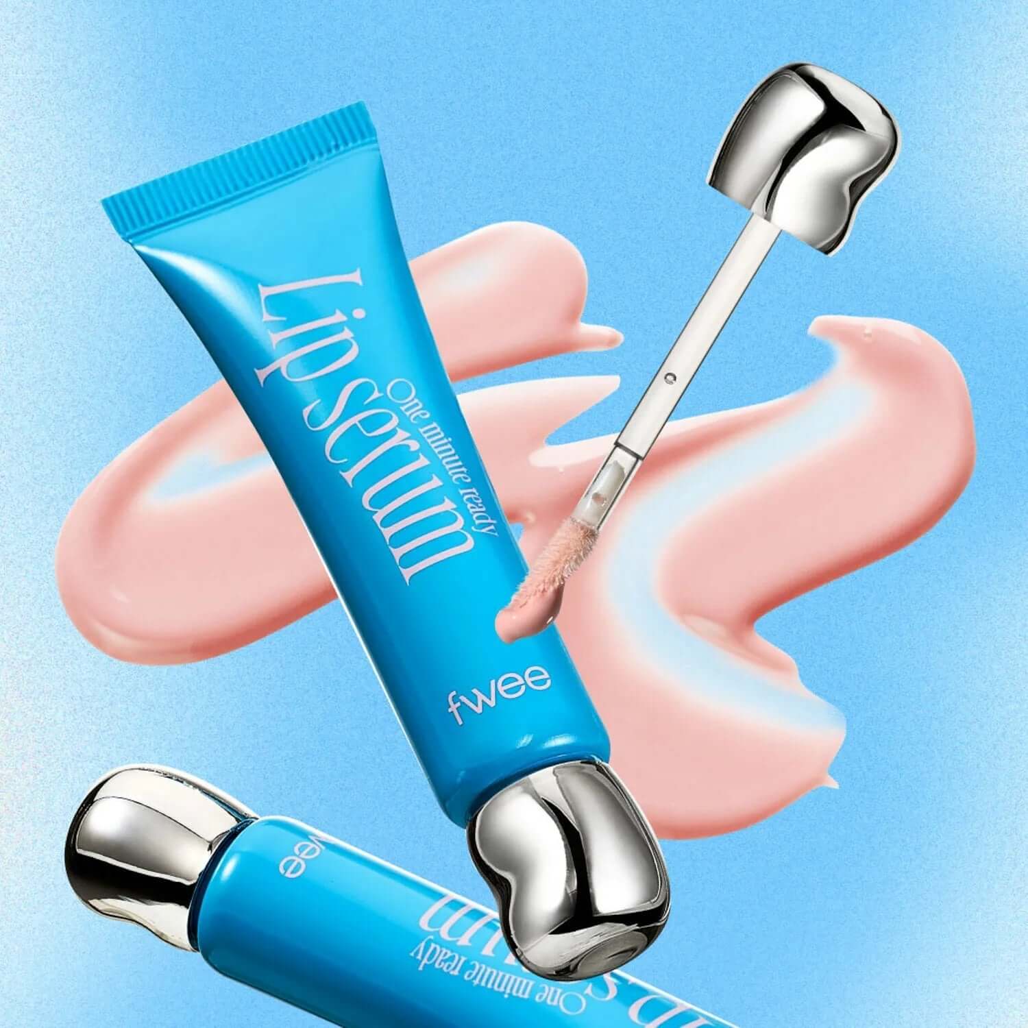 FWEE One Minute Ready Lip Serum tube with applicator on blue background, featuring pink serum texture.
