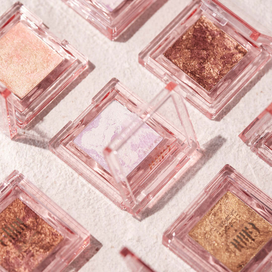 GLINT Glint Highlighter (Marble) in a stylish compact case on display among various shades.