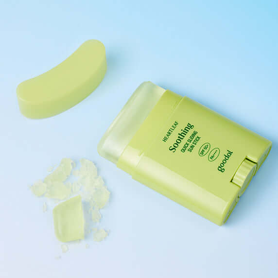 GOODAL Eoseongcho Calming Quick Sliding Sun Stick on a blue background with translucent contents beside the stick.