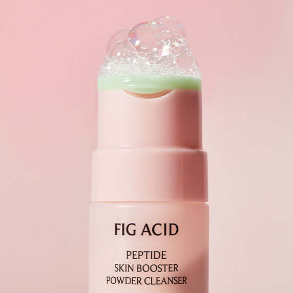 GOODAL Fig Acid Peptide Skin Booster Powder Cleanser bottle with bubbles on top, pink background. Enhance skincare routine.