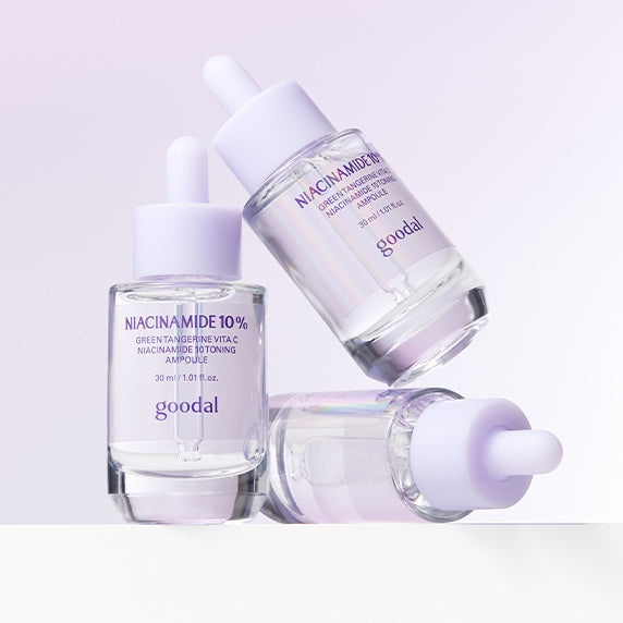 GOODAL Green Tangerine Vita C Niacinamide 10 Trace Ampoule bottles displayed on a reflective surface