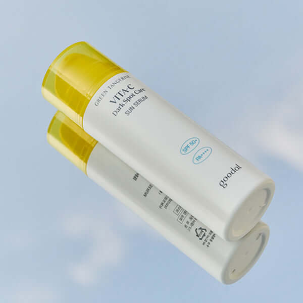 GOODAL Green Tangerine Vita C Spot Care Sun Serum 50ml against a clear sky background.
