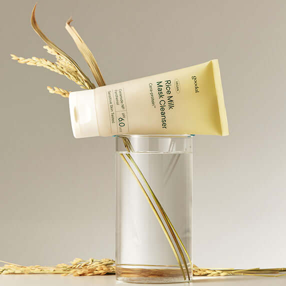 GOODAL Vegan Rice Milk Pack Cleanser tube displayed with rice stalks on a glass vase.