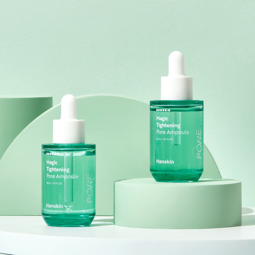 HANSKIN Magic Tightening Pore Ampoule 30ml displayed on elegant green background showing skincare product design with dropper.