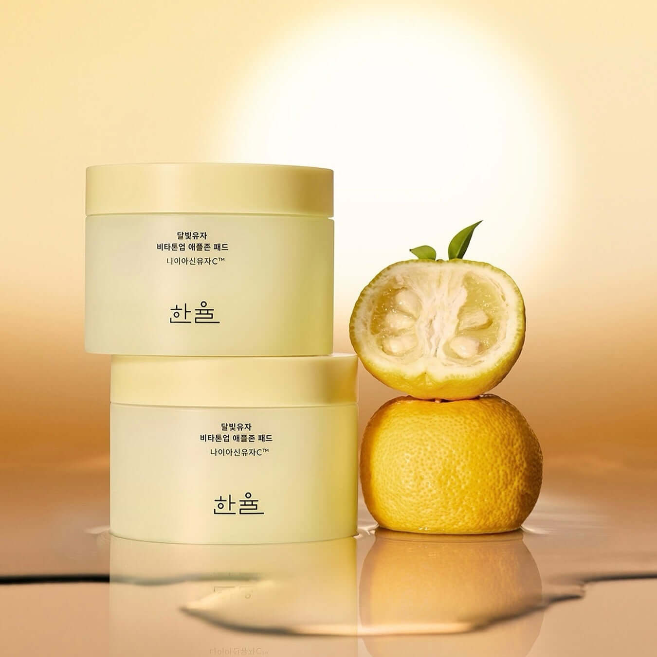 HANYUL Moonlight Yuja Vita Tone Up Apple Zone Pad in yellow packaging with yuja fruit, enhancing skin vitality and tone.